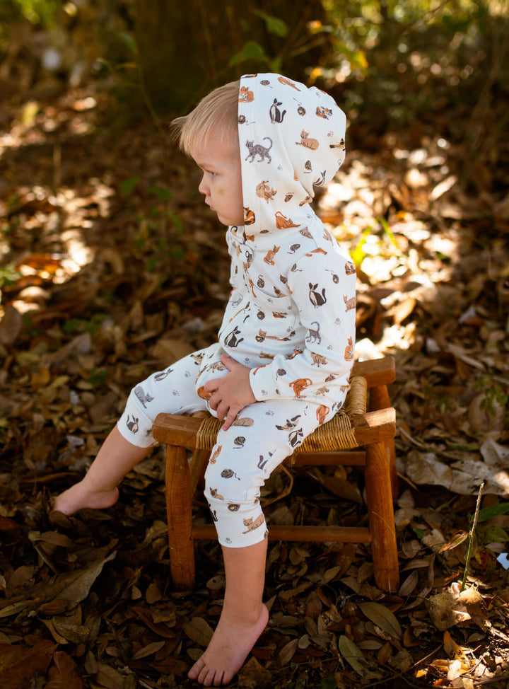 Child wearing Organic Hooded Zipper Romper in 9 Lives.
