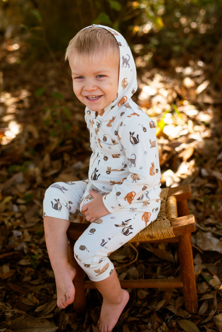 Child wearing Organic Hooded Zipper Romper in 9 Lives.