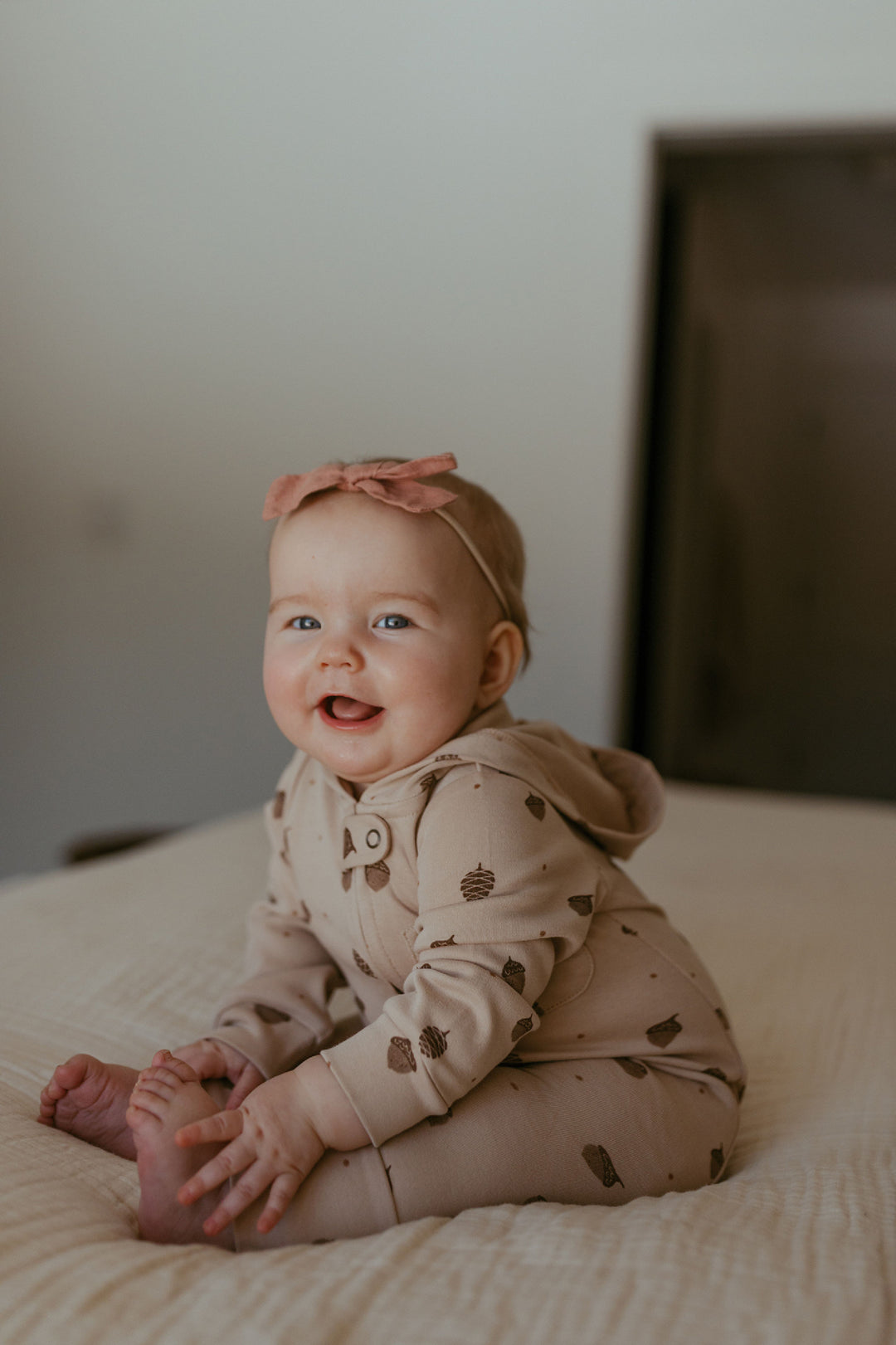 Child wearing Organic Hooded Zipper Romper in Little Acorn.