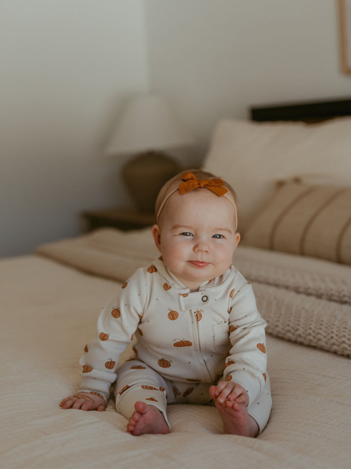 Child wearing Organic Hooded Zipper Romper in Pumpkin Spice.