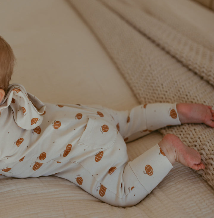 Child wearing Organic Hooded Zipper Romper in Pumpkin Spice.
