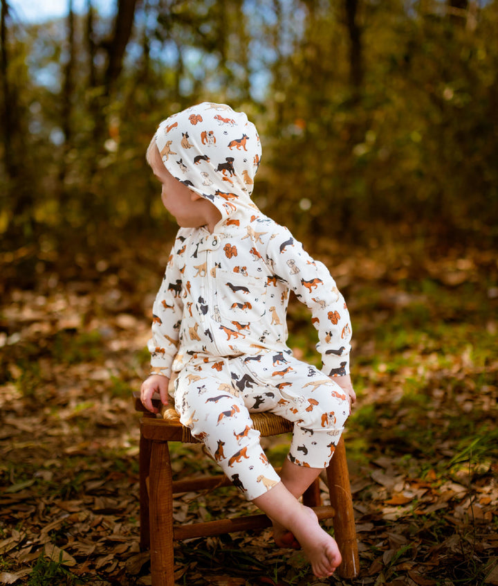 Child wearing Organic Hooded Zipper Romper in Puppy Love.
