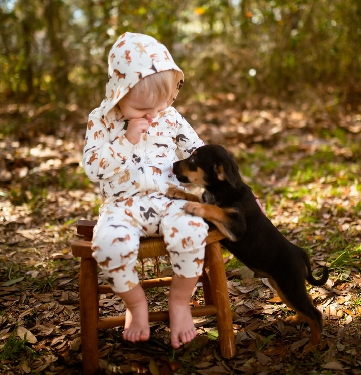 Child wearing Organic Hooded Zipper Romper in Puppy Love.