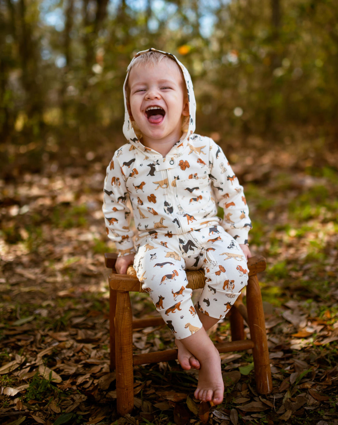 Child wearing Organic Hooded Zipper Romper in Puppy Love.