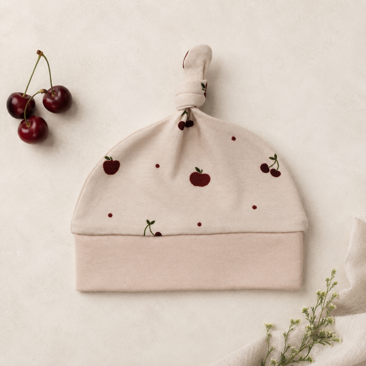 Organic Knotted Hat in Cherry Apple.