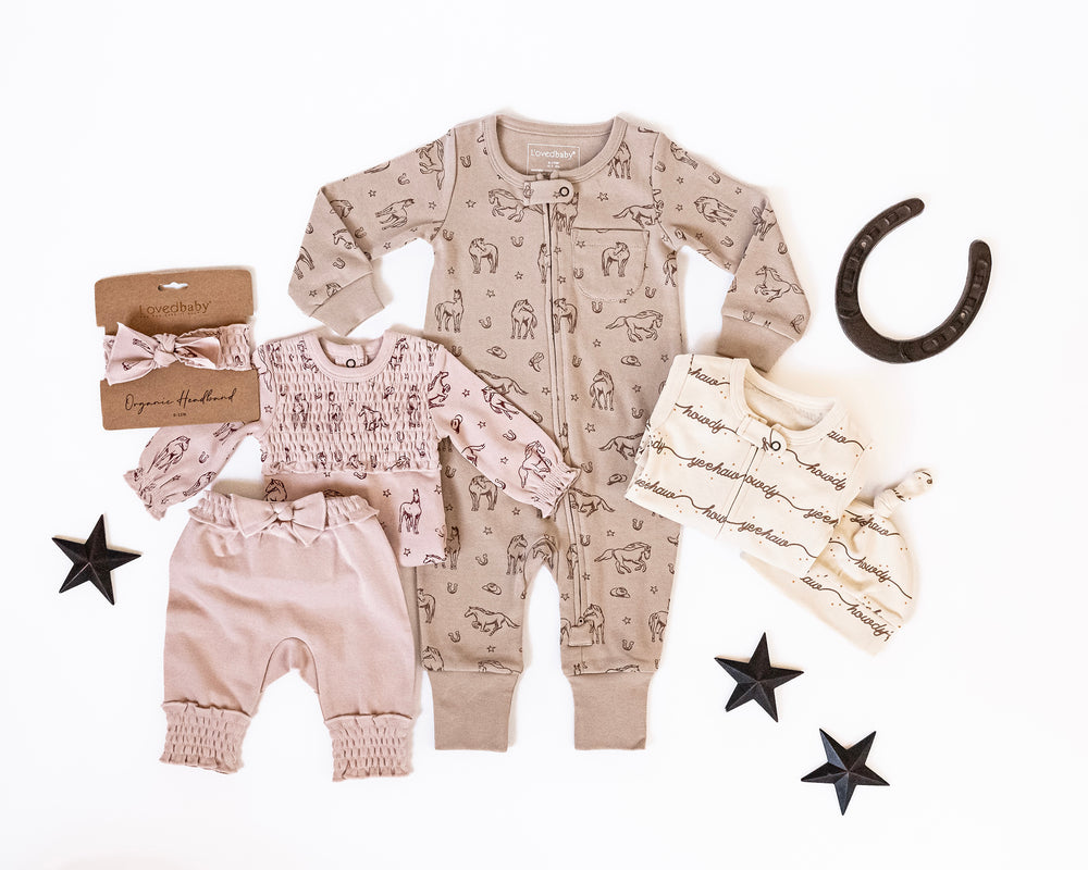 Child wearing Organic Footless 2-Way Zipper Romper in Mini Buckaroo.
