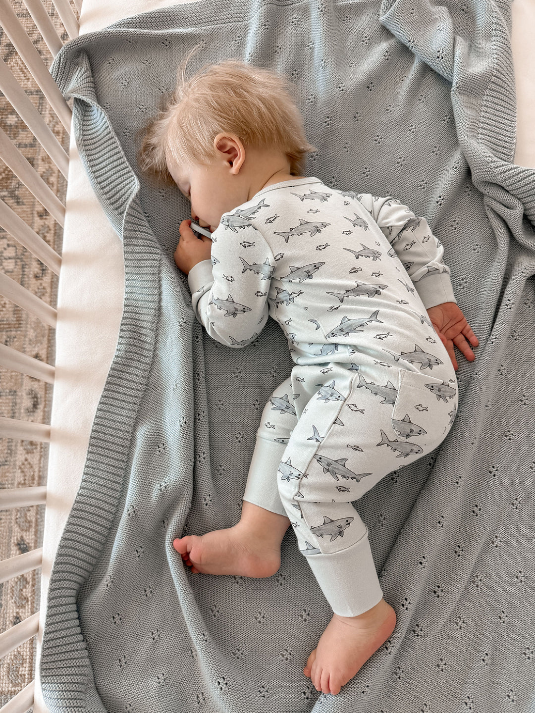Child wearing Organic Footless 2-Way Zipper Romper in Sharks.