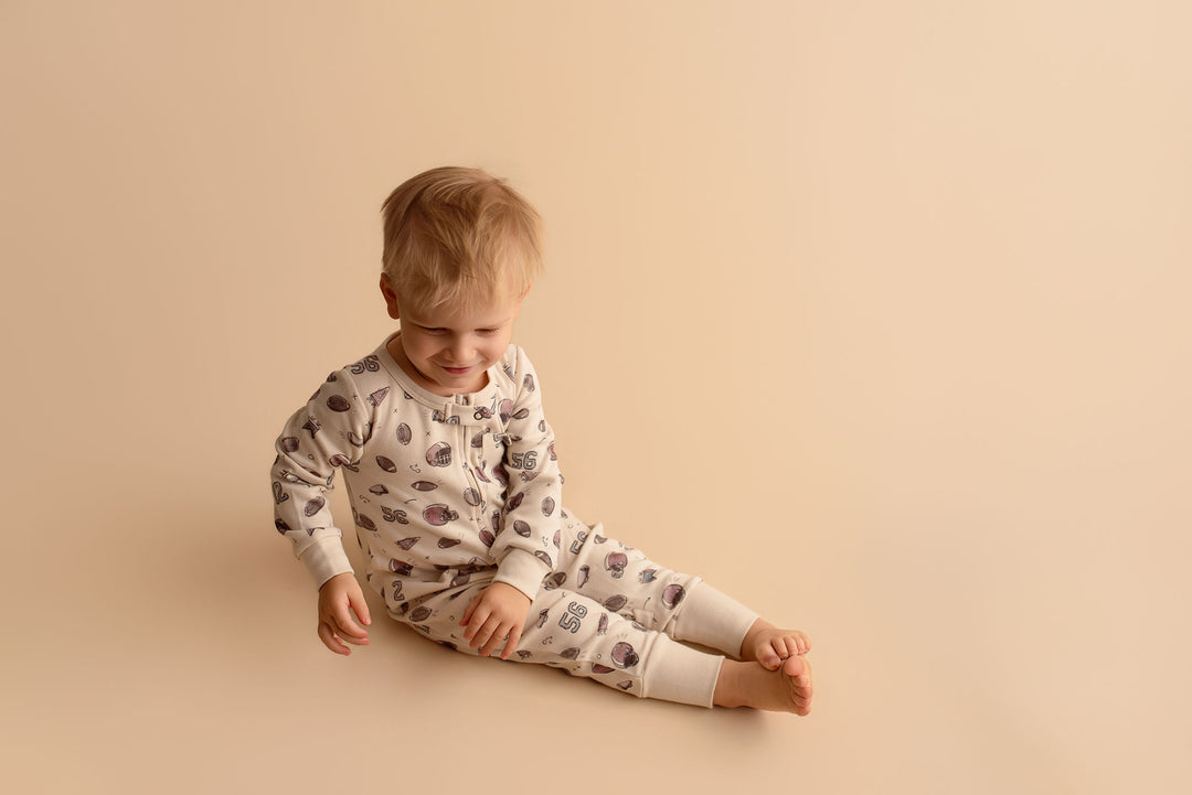 Child wearing Organic Footless 2-Way Zipper Romper in Touchdown.