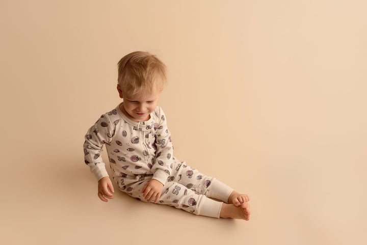Child wearing Organic Footless 2-Way Zipper Romper in Touchdown.