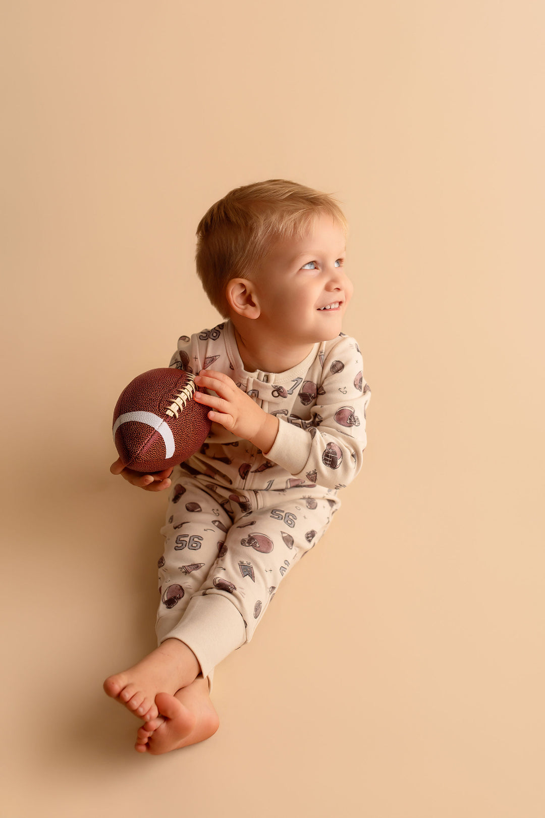 Child wearing Organic Footless 2-Way Zipper Romper in Touchdown.
