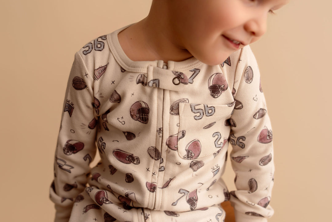 Child wearing Organic Footless 2-Way Zipper Romper in Touchdown.