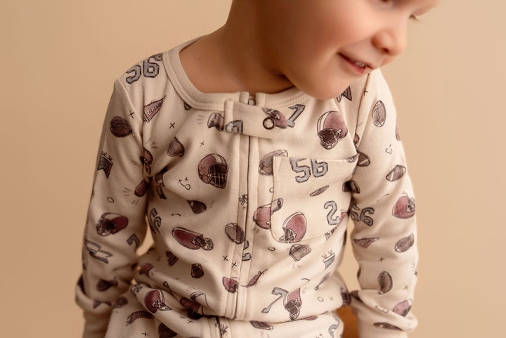 Child wearing Organic Footless 2-Way Zipper Romper in Touchdown.