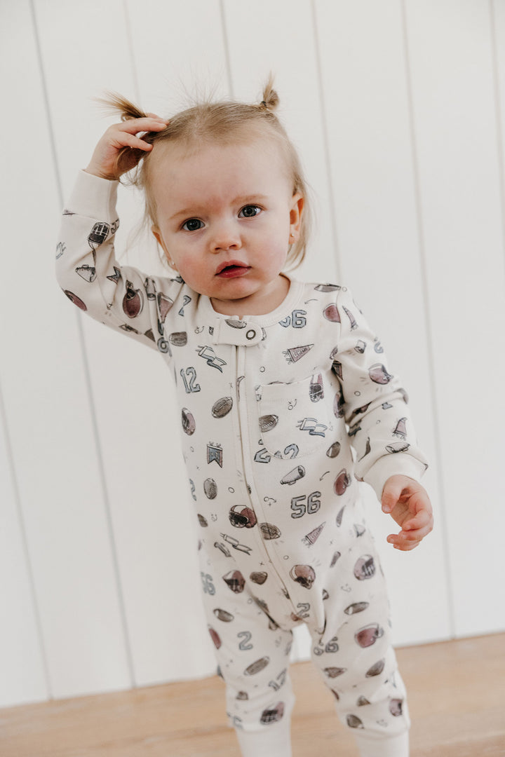 Child wearing Organic Footless 2-Way Zipper Romper in Touchdown.