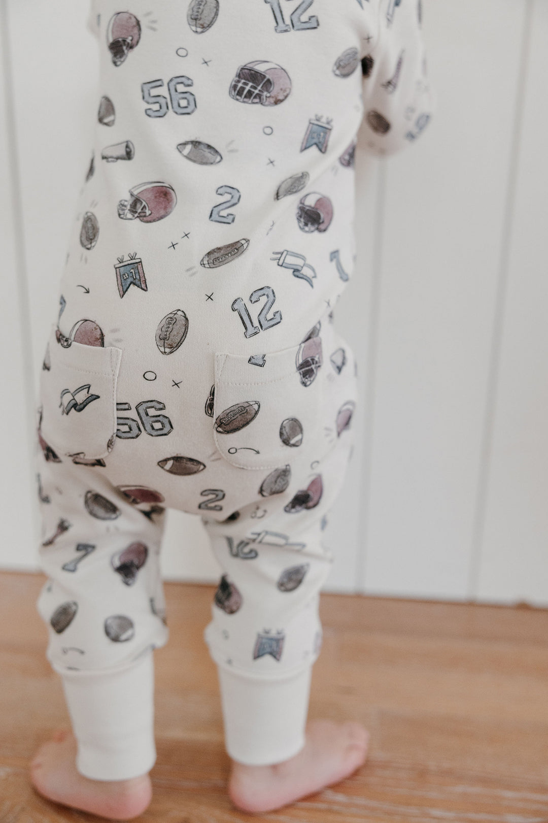 Child wearing Organic Footless 2-Way Zipper Romper in Touchdown.