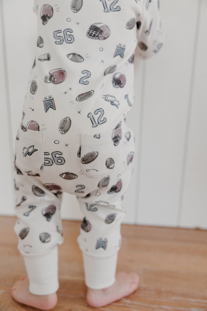 Child wearing Organic Footless 2-Way Zipper Romper in Touchdown.