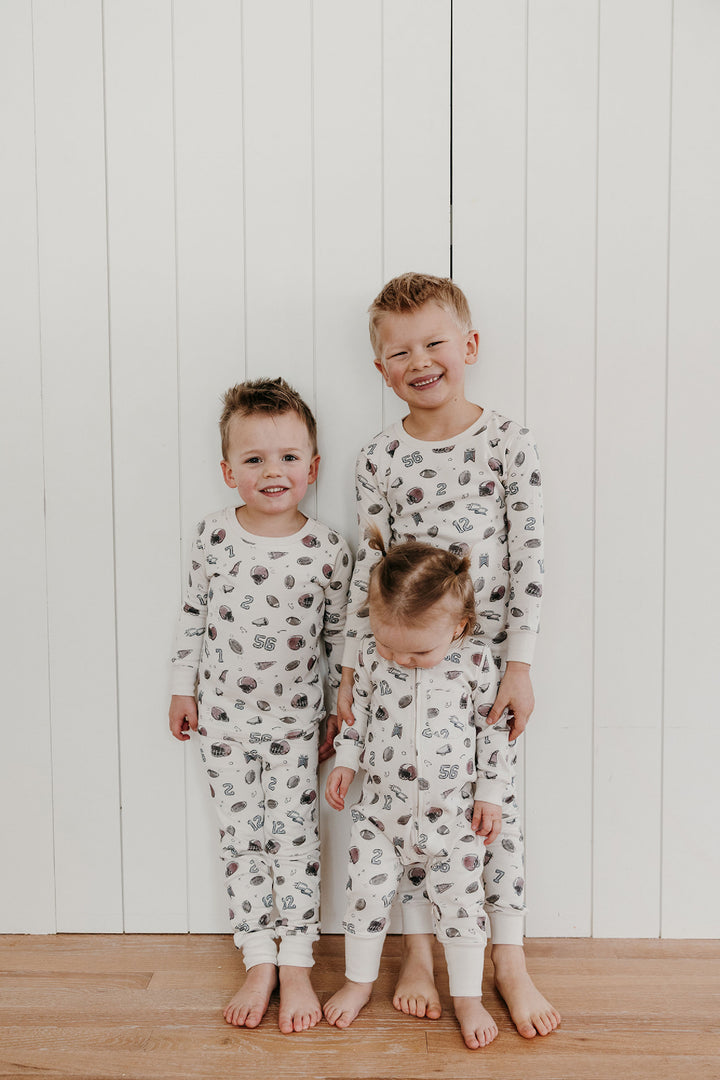 Child wearing Organic Footless 2-Way Zipper Romper in Touchdown.
