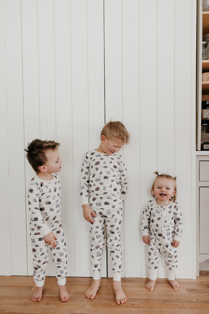 Child wearing Organic Footless 2-Way Zipper Romper in Touchdown.