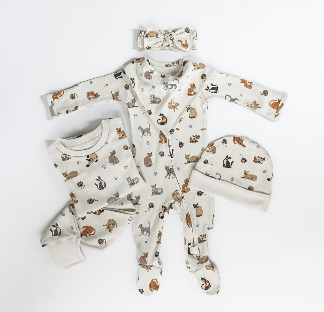 Child wearing Organic 2-Way Zipper Footie in 9 Lives.