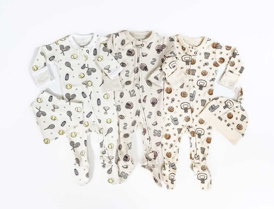Child wearing Organic 2-Way Zipper Footie in Little Ace.