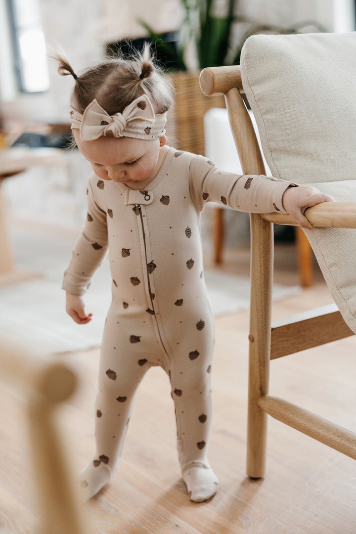 Child wearing Organic 2-Way Zipper Footie in Little Acorn.