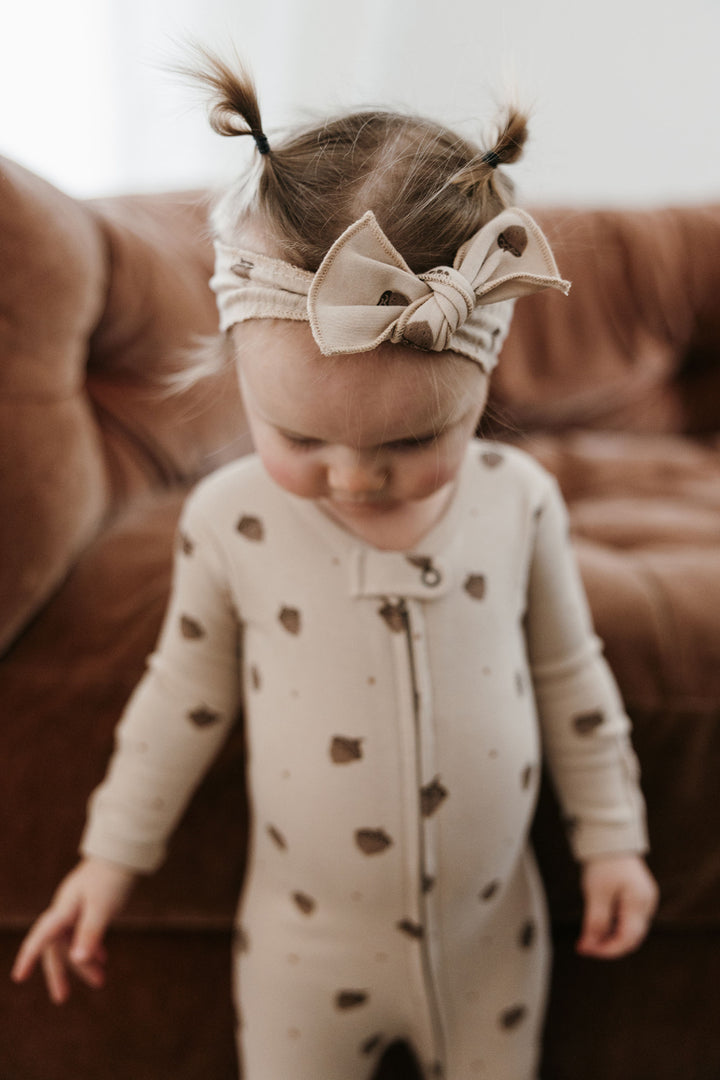 Child wearing Organic 2-Way Zipper Footie in Little Acorn.