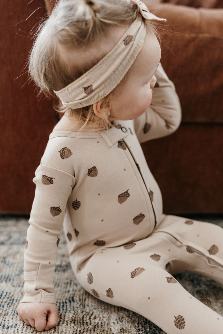 Child wearing Organic 2-Way Zipper Footie in Little Acorn.