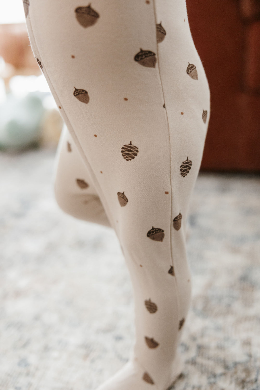 Child wearing Organic 2-Way Zipper Footie in Little Acorn.