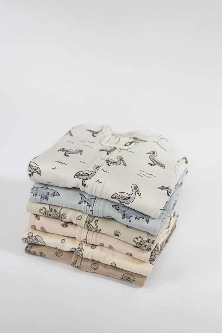 Child wearing Organic 2-Way Zipper Footie in Pelican.