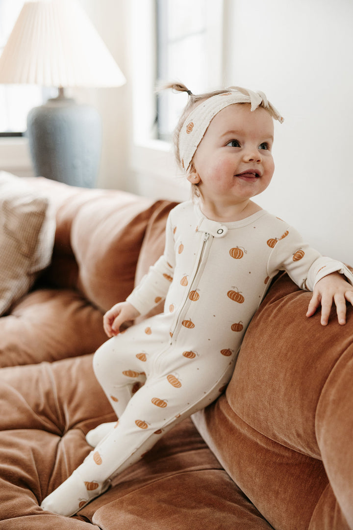 Child wearing Organic 2-Way Zipper Footie in Pumpkin Spice.