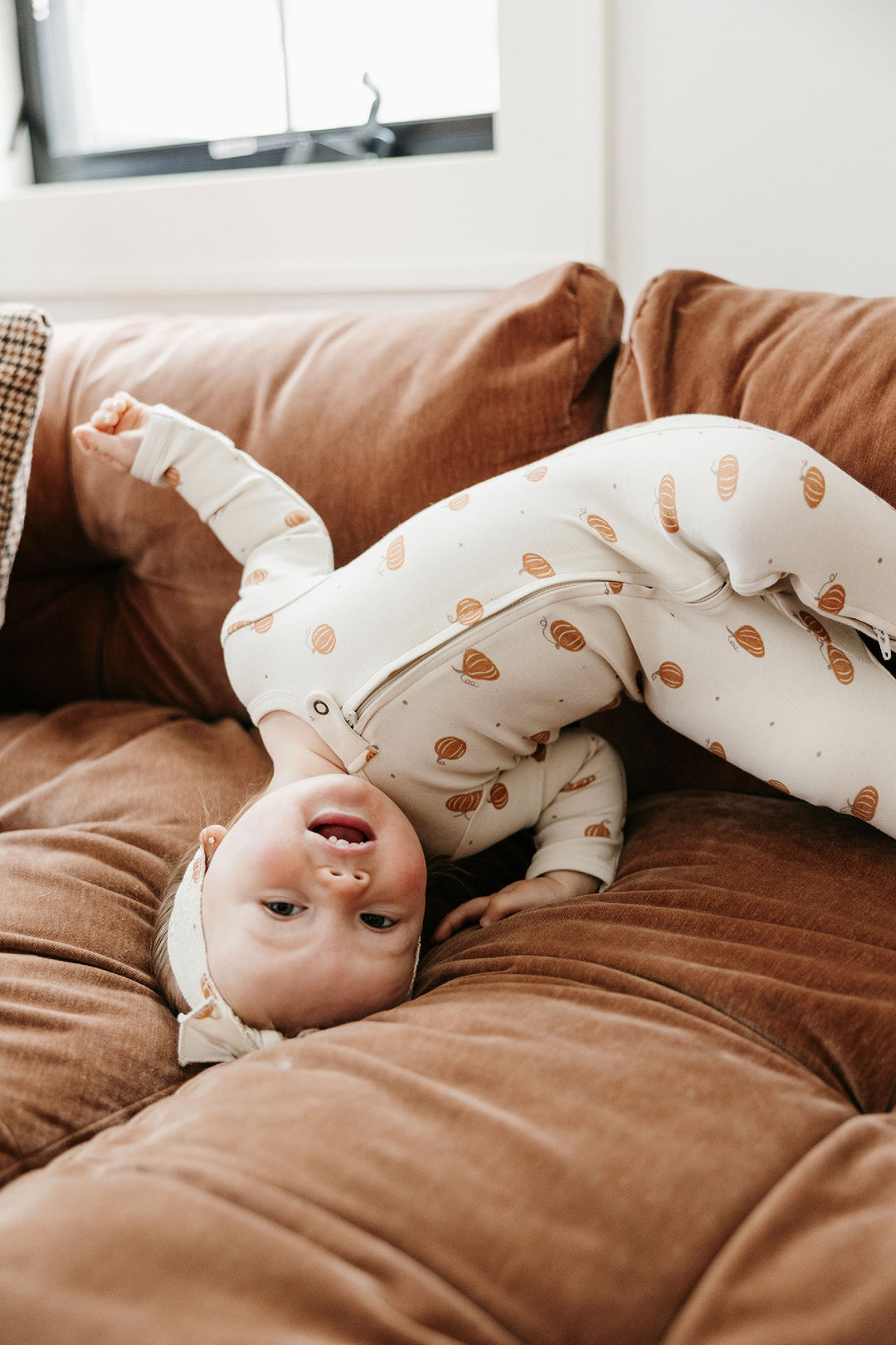 Child wearing Organic 2-Way Zipper Footie in Pumpkin Spice.