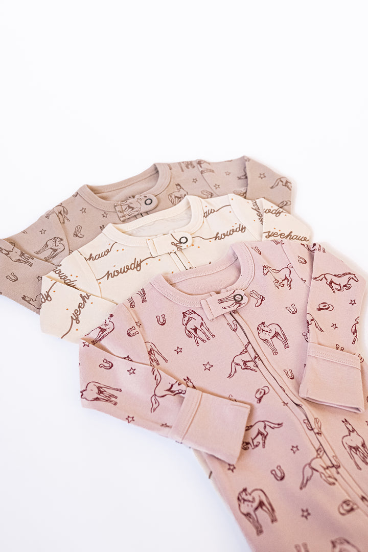 Child wearing Organic 2-Way Zipper Footie in Rodeo Rose.