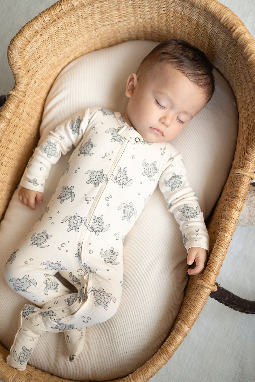 Child wearing Organic 2-Way Zipper Footie in Sea Turtles.