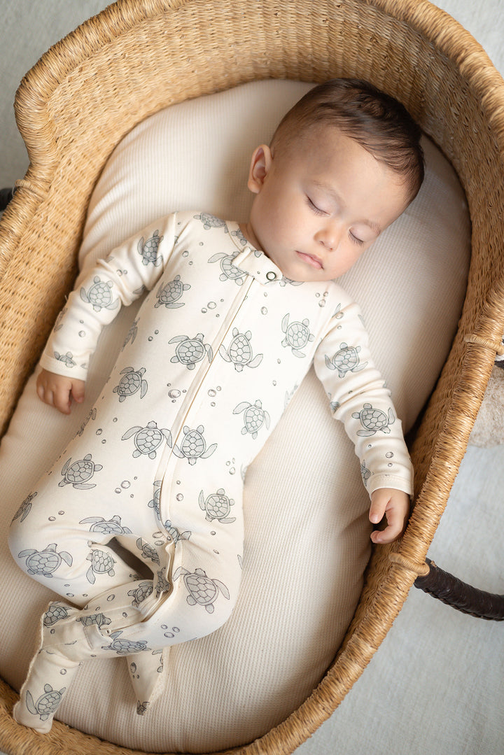 Child wearing Organic 2-Way Zipper Footie in Sea Turtles.