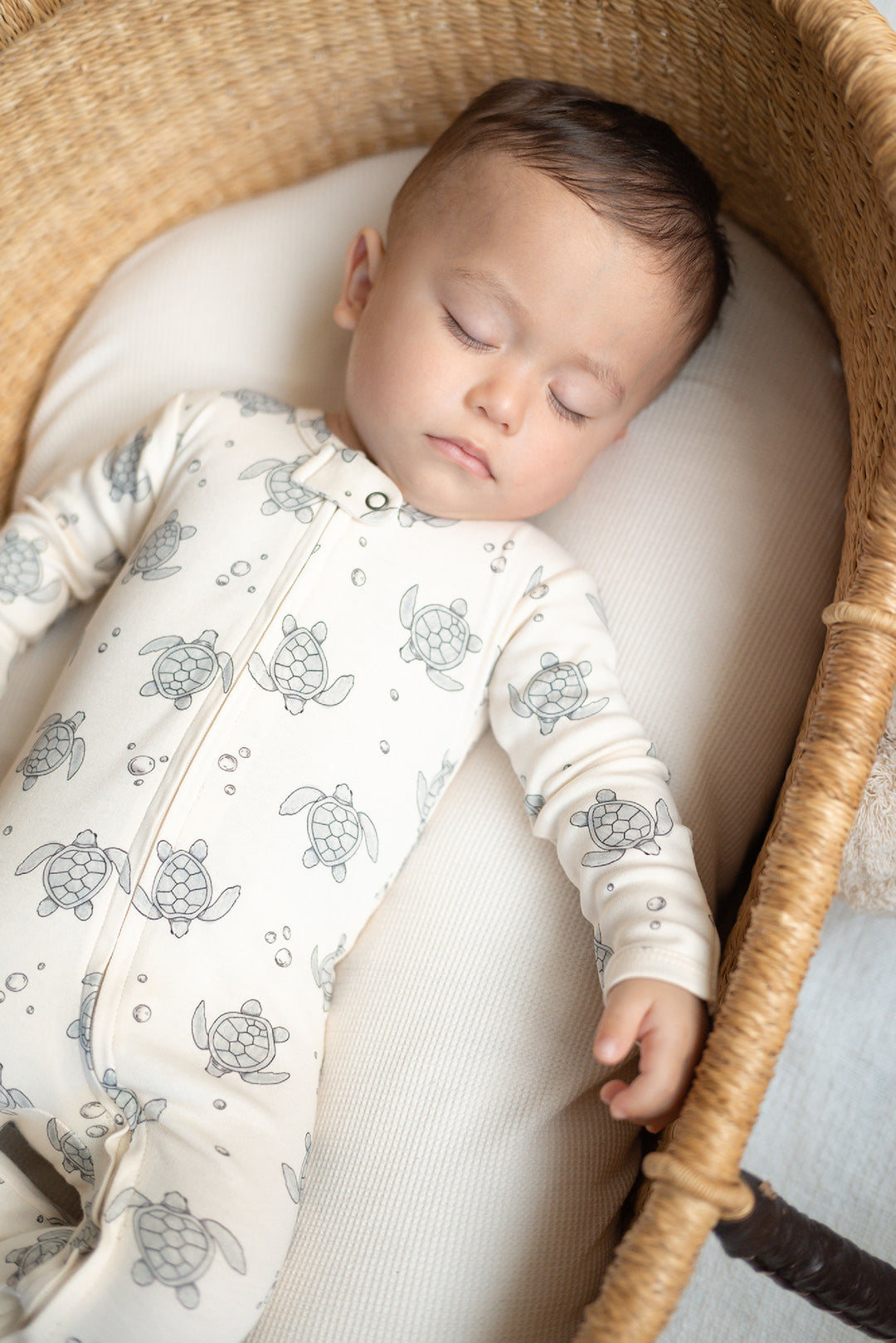 Child wearing Organic 2-Way Zipper Footie in Sea Turtles.