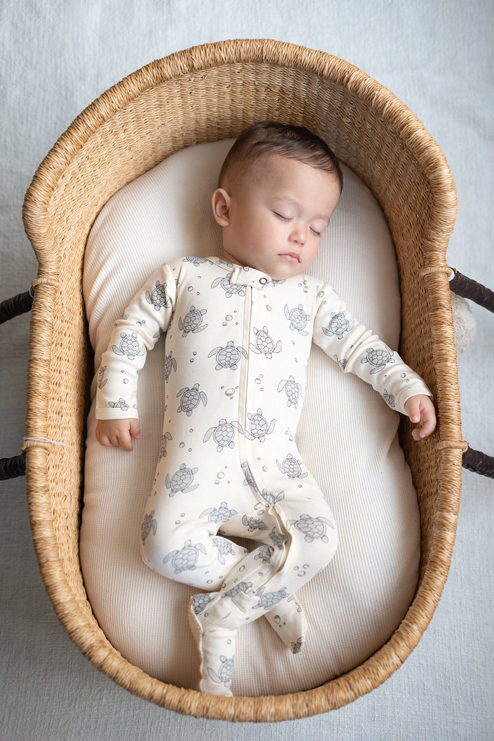 Child wearing Organic 2-Way Zipper Footie in Sea Turtles.