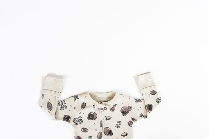 Child wearing Organic 2-Way Zipper Footie in Touchdown.