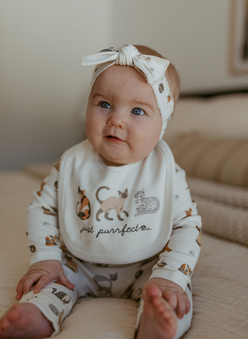 Child wearing Organic Smocked Tie Headband in 9 Lives.