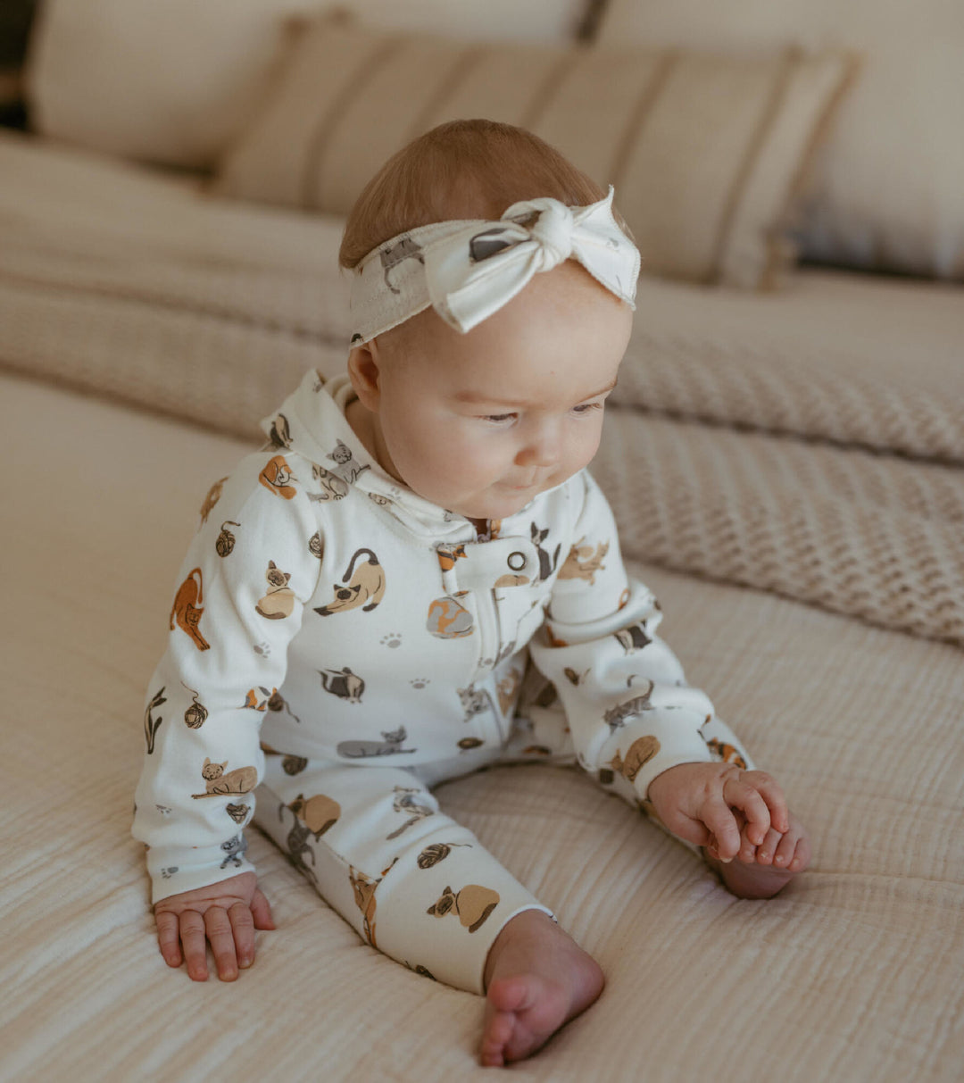Child wearing Organic Smocked Tie Headband in 9 Lives.