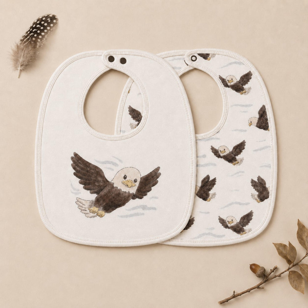 Child wearing Organic Reversible Bib in Bald Eagle.