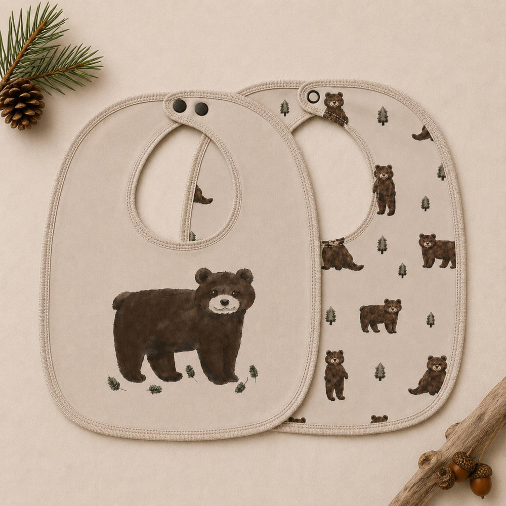 Child wearing Organic Reversible Bib in Black Bear.