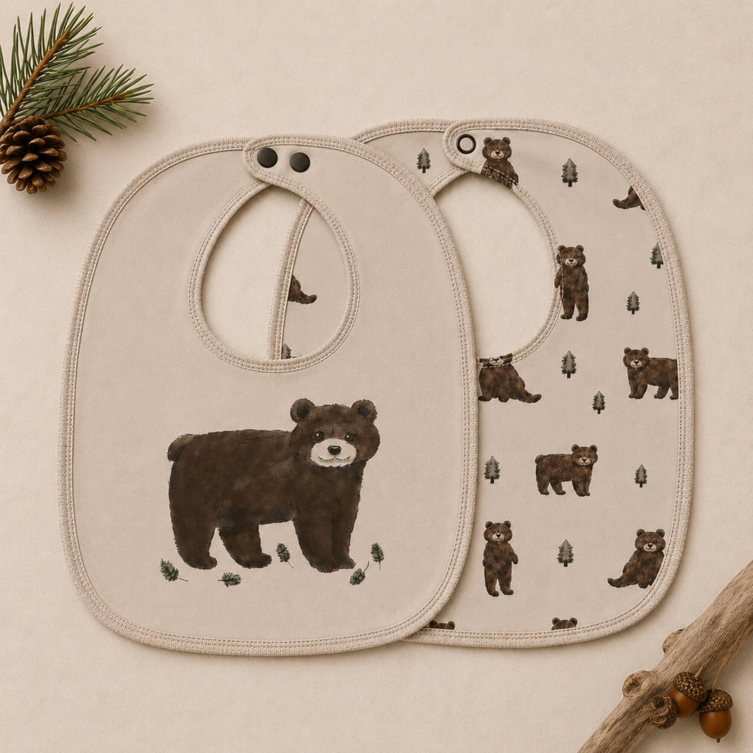 Child wearing Organic Reversible Bib in Black Bear.