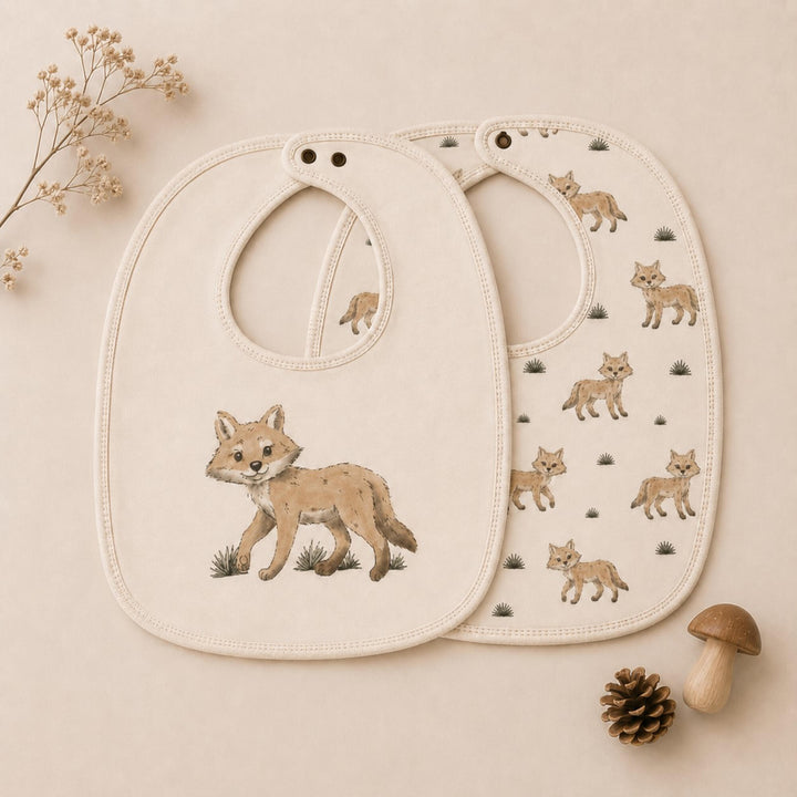 Child wearing Organic Reversible Bib in Coyote.