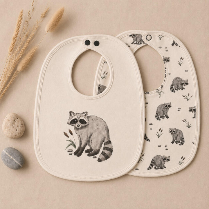 Child wearing Organic Reversible Bib in Raccoon.