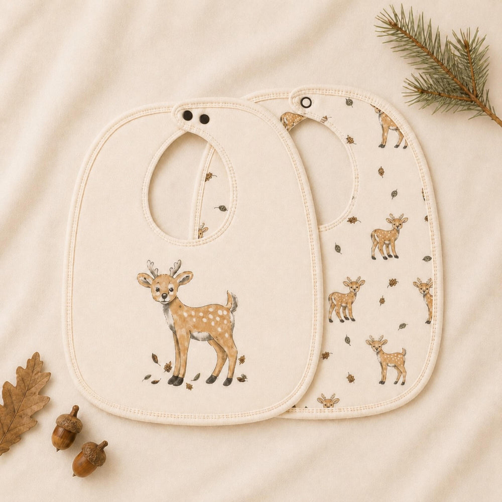 Child wearing Organic Reversible Bib in White Tail Deer.