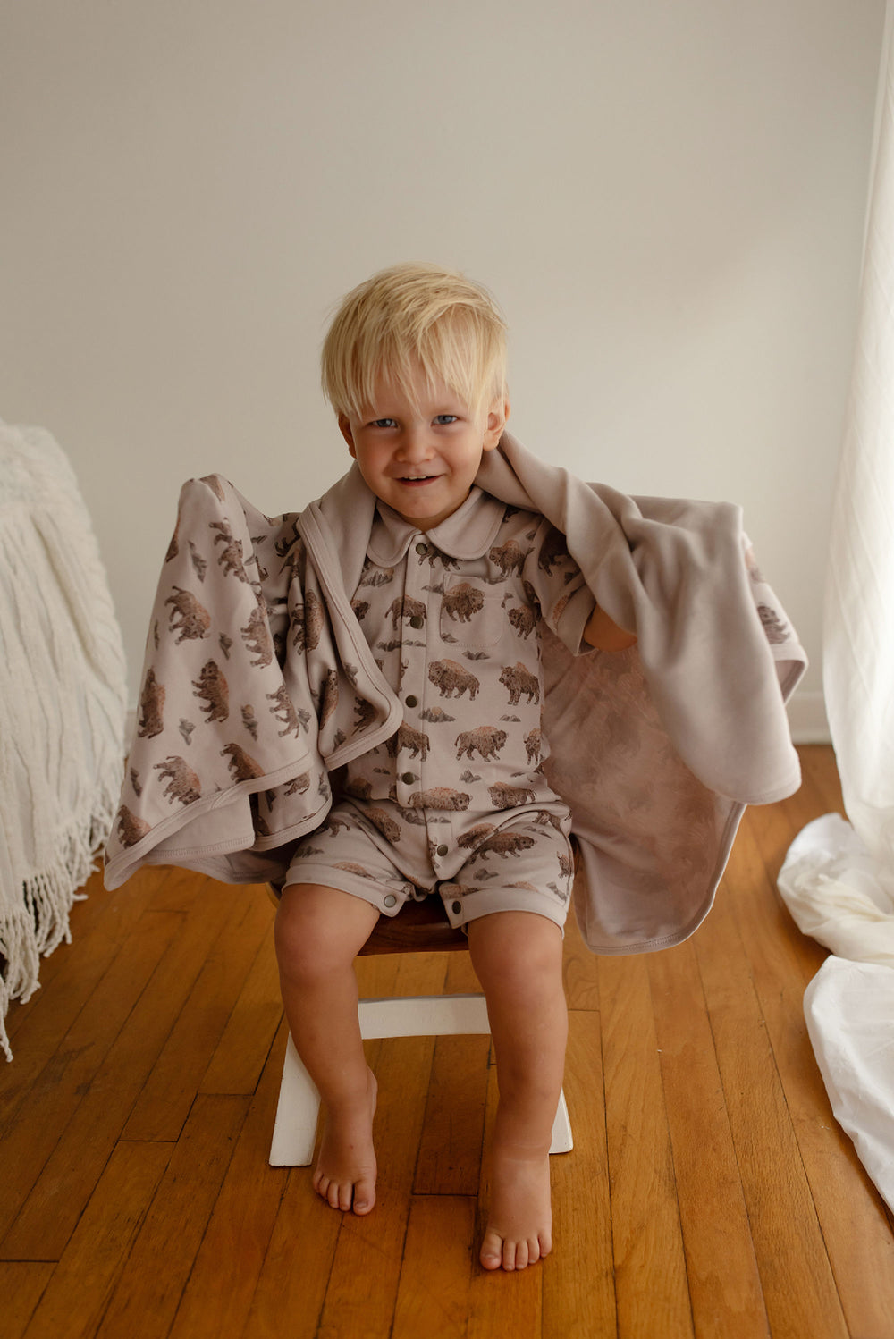 Child wearing Organic Blanket in Bison.
