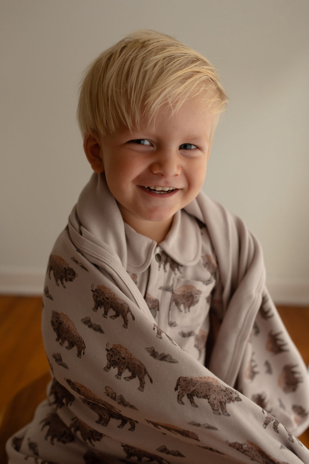 Child wearing Organic Blanket in Bison.