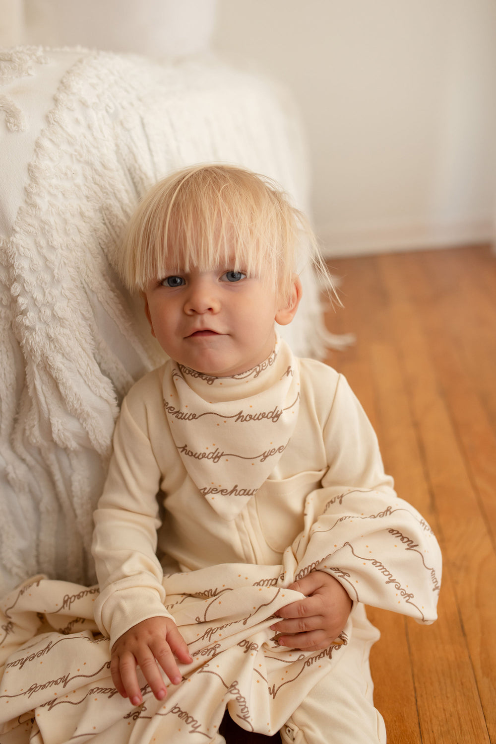 Child wearing Organic Blanket in Howdy.