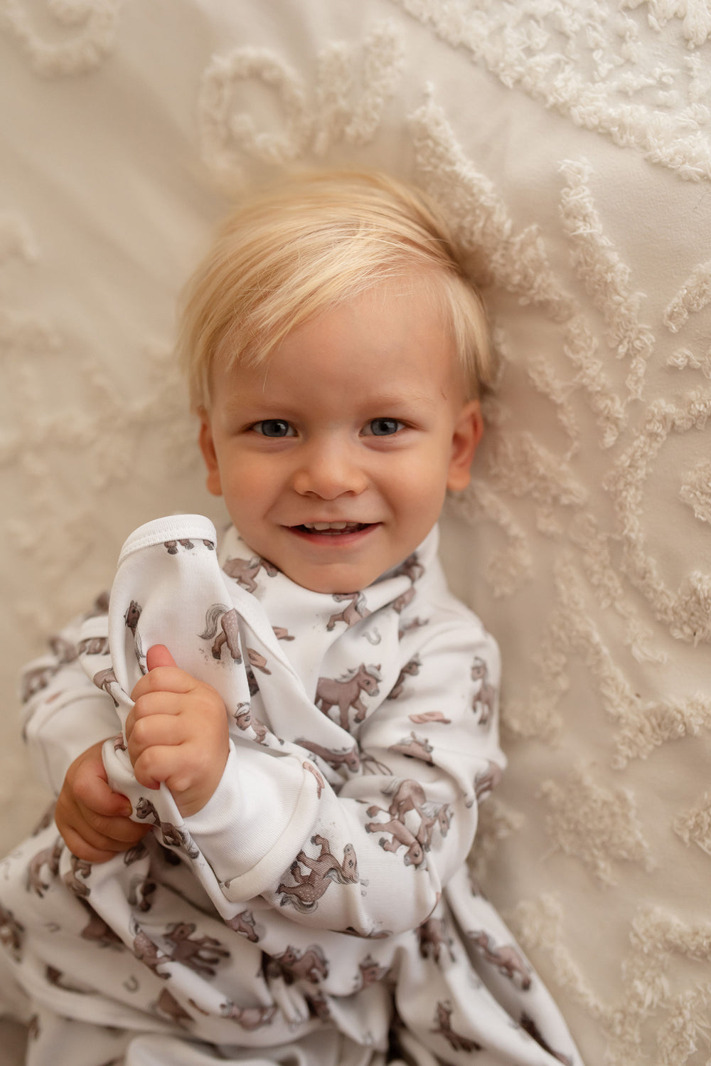 Child wearing Organic Blanket in Little Lasso.