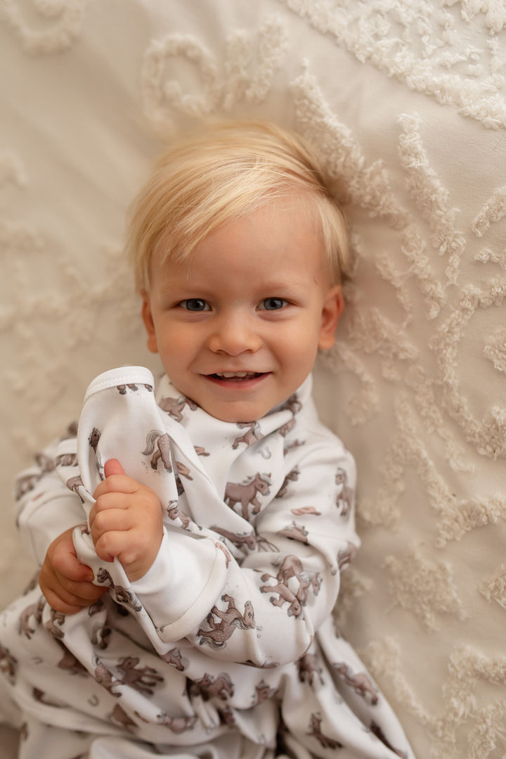 Child wearing Organic Blanket in Little Lasso.