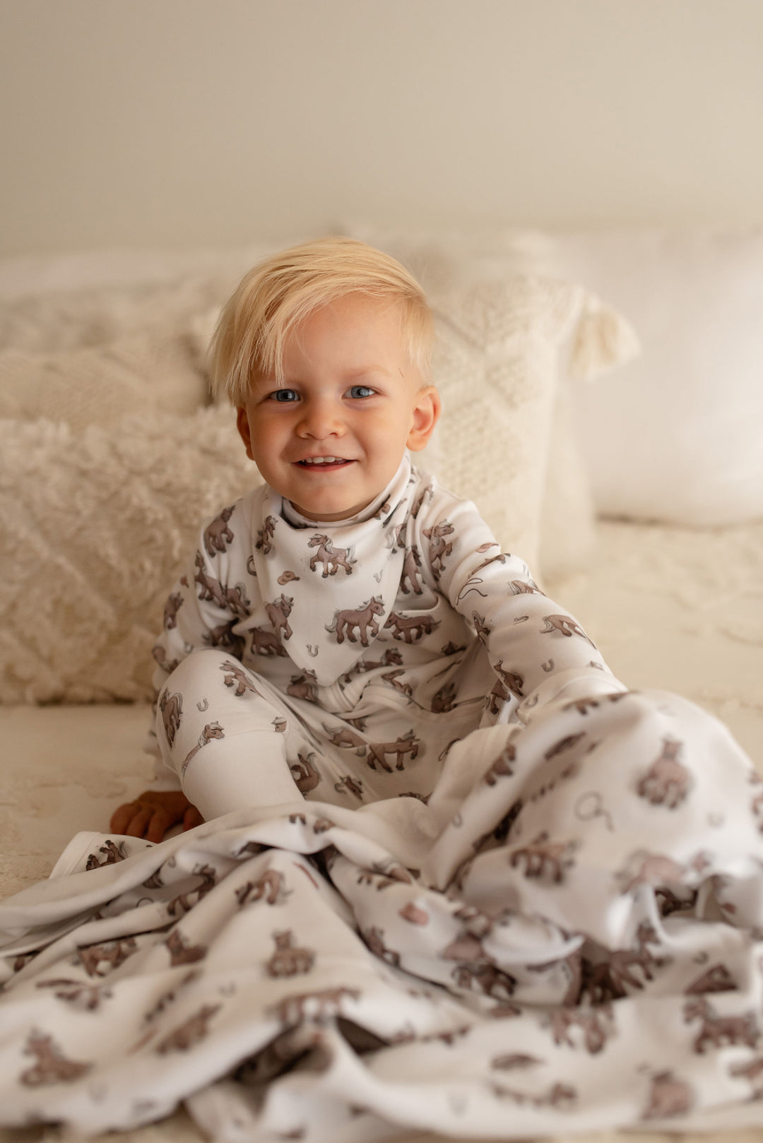 Child wearing Organic Blanket in Little Lasso.